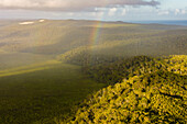 Aerial photograph of a rain squall & rainbow over Great Sandy National Park, Sunshine Coast, Queensland, Australia