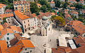 Aerial view of saint michael archangel church surrounded by picturesque rooftops and quaint town square, herceg novi, montenegro.