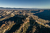 Aerial view of Civita di Bagnoreggio, a beautiful old town with badlands (Calanchi) in background, Viterbo, Lazio, Italy.
