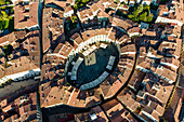 Aerial view of Piazza dell'Anfiteatro, a medieval square with cafè and market in Lucca old town, Tuscany, Italy.
