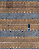 Aerial view of a car parked in an empty Parking lot in Cacilhas, Almada, Portugal.