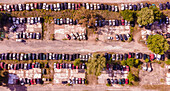 Aerial view of an abandoned junkyard with vehicles parked in a parking lot in Carnide, Lisbon, Portugal.