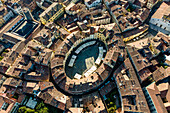 Aerial view of Piazza dell'Anfiteatro, a medieval square with cafè and market in Lucca old town, Tuscany, Italy.
