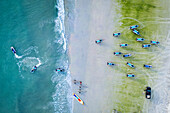 Aerial view of a beautiful tropical beach with jetskis and people enjoying water fun, Kampung Lubok Buaya, Malaysia.