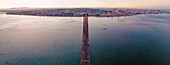 Panoramablick aus der Vogelperspektive auf die Autobahn am 25. April, Brücke über den Tejo mit der Innenstadt von Lissabon im Hintergrund, Lissabon, Portugal.