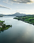 Aerial view of Mount Pilatus at sunset from Lake Lucerne, a mountain peak in Alpnach, Switzerland.