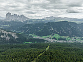 Aerial view of Ortisei, a small village on the Dolomites mountains with Sassolungo Mountain in background (Langkofel), Trentino, South Tyrol in Northern Italy.
