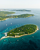 Aerial view of sailboat moored along Kotez Island at Brijuni National Park, a group of islands along the Adriatic Sea coastline near Pula, Istria, Croatia.