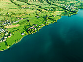 Aerial view of residential houses along Lake Lucerne at sunset, from Kussnacht am Rigi, Schwyz, Switzerland.