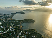 Aerial view of Cala del Vecchio Pozzo with Vivara Island in background, a small bay with high cliffs on the Procida island at sunset, Flegree Islands archipelagos, Naples, Campania, Italy.