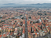 Aerial view of a big residential district in Florence outskirts with mountains in background, Florence, Tuscany, Italy.