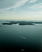 Aerial view of Brijuni National Park, a group of islands along the Adriatic Sea coastline with a misty fog at sunset near Pula, Istria, Croatia.