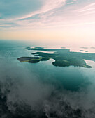 Aerial view of Brijuni National Park, a group of islands along the Adriatic Sea coastline with a misty fog at sunset near Pula, Istria, Croatia.