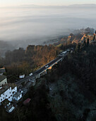 Aerial view of balze valdarno with fog and mist at sunrise featuring a bridge and cars, piantravigne, arezzo, italy.