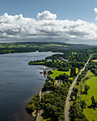 Aerial view of tranquil Loch Lomond surrounded by lush trees and scenic hills, Alexandria, United Kingdom.