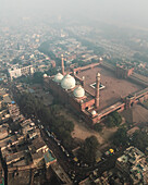 Aerial view of the bustling cityscape featuring the historic Jama Masjid mosque amidst crowded streets, Chandni Chowk, New Delhi, India.