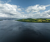 Aerial view of tranquil Loch Lomond with lush greenery and scenic islands, Trossachs National Park, Scotland, United Kingdom.