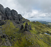 Aerial view of the iconic old man of storr amidst rugged cliffs and lush greenery, Scottish Highlands, Isle of Skye, United Kingdom.