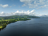 Aerial view of tranquil Loch Lomond surrounded by lush greenery and serene mountains, Trossachs National Park, Scotland, United Kingdom.