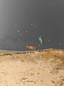 Aerial view of boats on the serene Yamuna river with birds flying above, Sadar Bazar, New Delhi, India.