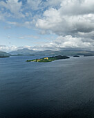 Aerial view of tranquil Loch Lomond with picturesque islands and serene water, Alexandria, Scotland, United Kingdom.