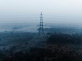 Aerial view of serene landscape with fog and power lines, Sadar Bazar, New Delhi, India.