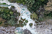 Aerial view of Terme di Petriolo, Hot springs along the banks of a small river, set in a wooded valley, Monticiano, Grosseto, Tuscany, Italy.
