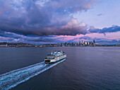 Aerial view of beautiful skyline over Elliot Bay with Washington State Ferry at dusk, Seattle, United States.
