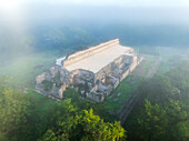 Aerial view of ancient ruins and a temple surrounded by lush jungle, Santa Elena, Mexico.