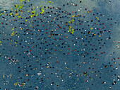 Aerial view of vibrant polo fishing activity on a clear river with people engaged in traditional fishing, Parbhanguria, Bhangura, Bangladesh.