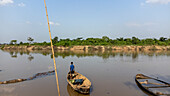 Aerial view of serene Ogun River with traditional wooden boats and lush greenery, Ifo, Nigeria.