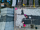 Aerial view of fish processing using traditional techniques with people working on rooftops, Chittagong, Bangladesh.