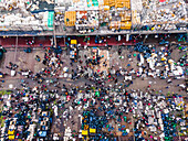 Aerial view of bustling fishery market with colorful stalls and crowd, Chittagong, Bangladesh.