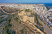 Aerial view of the Alcazaba of Almería with the wall going across the valley to the other side of the fortress and the city in the background of Almería, Andalusia, Spain.
