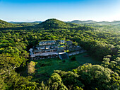 Aerial view of ancient ruins amidst lush jungle and hills, Oxkutzcab, Yucatan, Mexico.