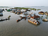 Aerial view of flooded village with boats and damaged homes, Jatrapur, Kurigram, Bangladesh.
