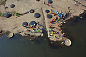 Aerial view of Hampi, pilgrims on Tungabhadra River, Karnataka, India.