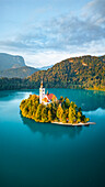 Aerial drone view of Lake Bled with famous church on the island during sunrise, Slovenia