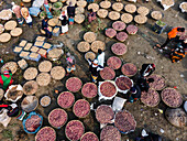 Aerial view of a vibrant winter market with vegetable baskets and people selling fresh produce, Brahmanbaria, Bangladesh.