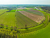 Aerial view of fruit orchard and farmland along river Linge, Deil, Betuwe, Gelderland, Netherlands.