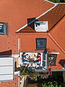Aerial view of couple having breakfast on roof terrace. Fun concept for people living in the city.