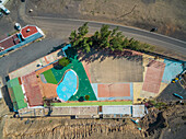 Aerial view of a vintage colorful sports playground in Pozo Negro in Fuerteventura, Canary Islands.
