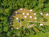 Aerial view of camping houses in the middle of the forest in the Soca valley, near Bovec, Slovenia.
