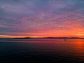 Aerial view of a dramatic sunset along the Adriatic sea coastline near Pula, Istria, Croatia.