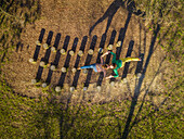 Aerial view of couple kissing son over wooden stumps, Zagreb, Croatia.