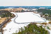 Aerial view of skaters on a frozen lake in a forest, Buurserzand, Twente, Overijssel, Netherlands