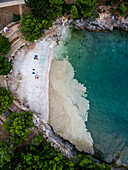 Aerial view of beach with algae accumulation and clear water, Pula, Croatia.