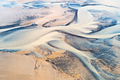 Abstract aerial view of sandbanks in the fjord Kaldalon where water from the glacier Drangjokull flows towards the sea, Westfjords, Iceland