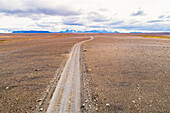 Aerial view of Kjolur 4WD road through desolate barren landscape in the highlands, Iceland