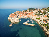 Aerial view of old city of Dubrovnik (Croatia) with old port in front. Dubrovnik is popular tourist attraction on Adriatic.